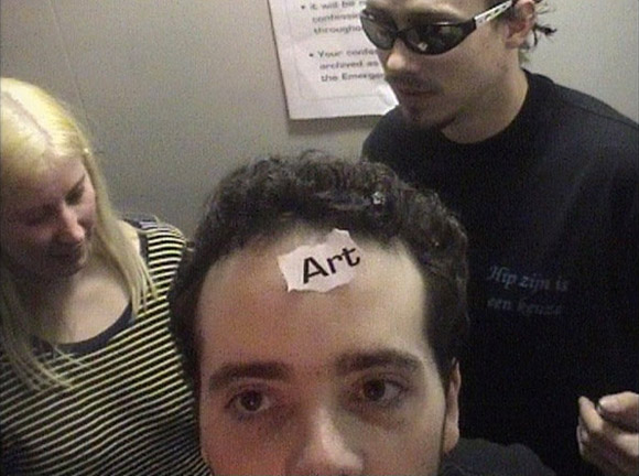 the word 'art' is stuck to his head
